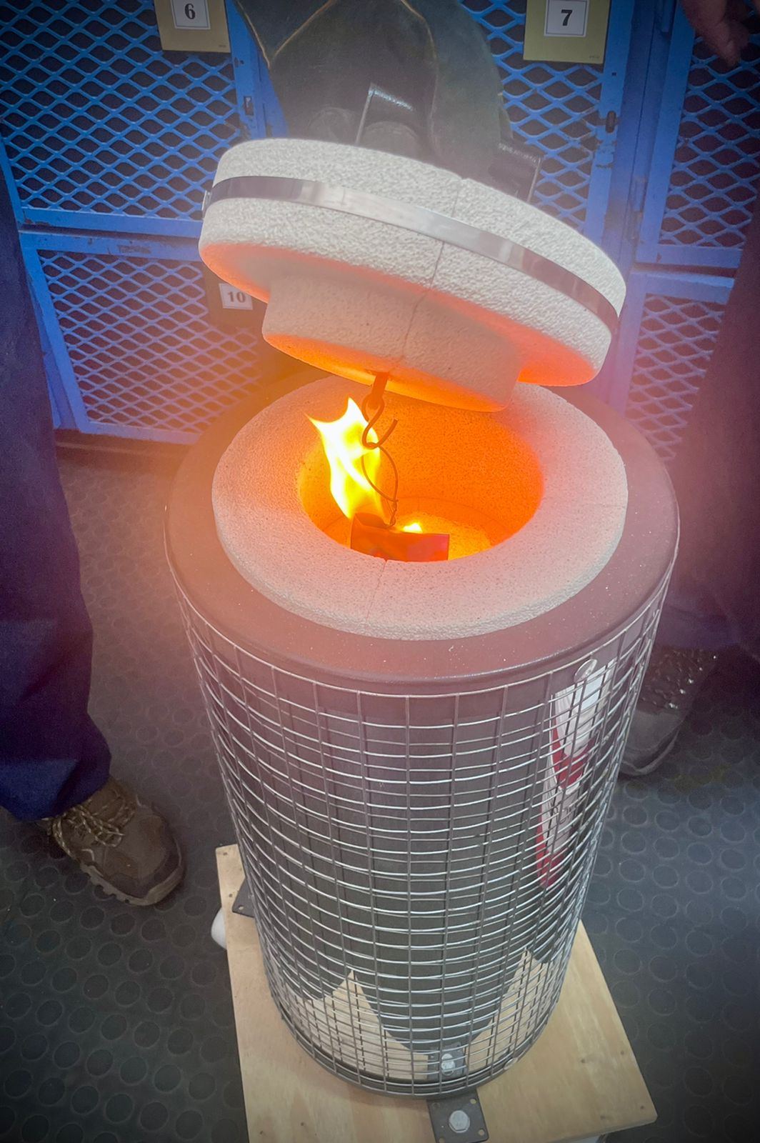 A blade glowing orange during heat treatment in the kiln